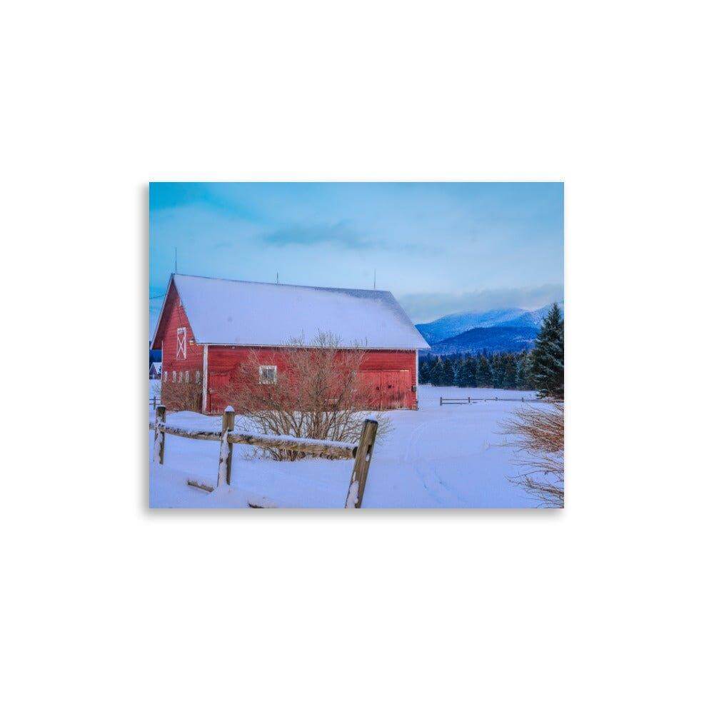 Matte-finish poster of a red barn in a snowy mountain landscape, showcasing giclée printing quality for decor.